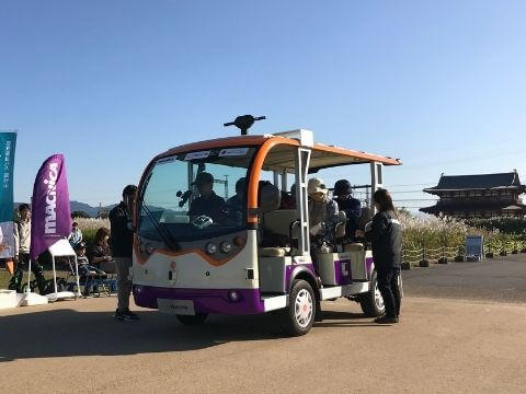 A autonomous driving cart riding in a park