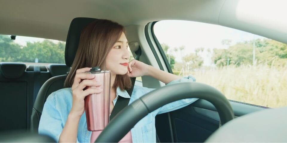 Japanese woman looking outside in the driver's seat