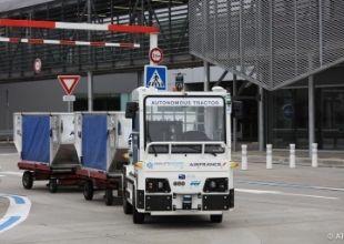 Self-autonomous driving tow tractor transporting containers at Toulouse Airport, France