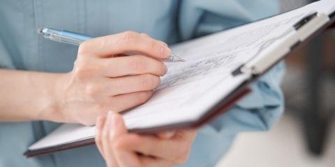 A worker filling out a check sheet