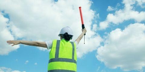 Security guard holding a carrot stick